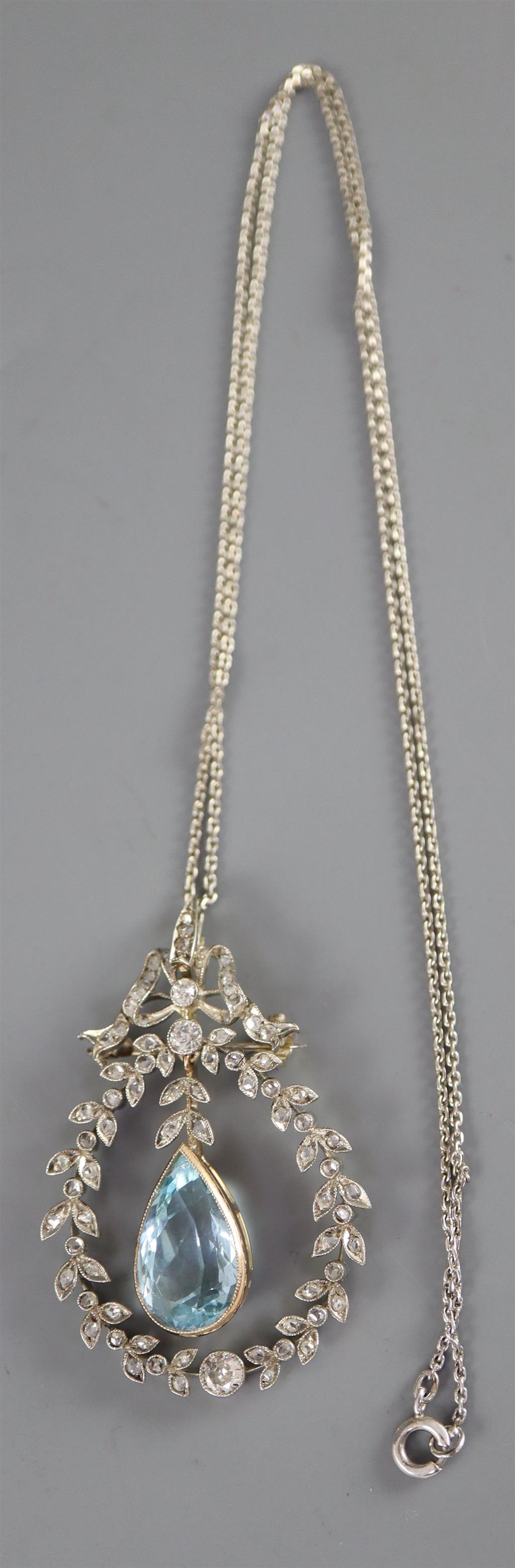 An Edwardian white and yellow gold, aquamarine and round and rose cut diamond set openwork drop pendant, on a fine link chain,